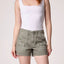 Woman wearing white sleeveless tank top and khaki cargo shorts with front patch pockets and distressed hem
