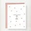Wedding congratulations greeting card with rose gold foil hearts and Mr. and Mrs. text on white cardstock with pink envelope