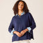 Woman wearing navy Frenchie Zip Size Crewneck sweatshirt with light denim collar and cuffs, styled with gold chain necklace