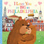 Brown bear hugging smaller bear with Philadelphia skyline and landmarks in background, pink hearts floating above text readi…