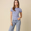Woman wearing blue and white striped short-sleeve baby tee with contrast trim paired with light wash jeans