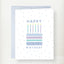 Happy Birthday greeting card featuring a colorful patterned cake with six lit candles and blue polka dot background