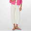 Woman wearing cream barrel crop jeans with pink cardigan and olive strappy sandals