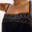 Woman wearing a black dress with intricate gold beading