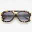 Yellow tortoise sunglasses against a white background.