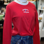 Red long-sleeve Philadelphia Phillies tee with white arch logo and blue P symbol, styled with dark jeans and gold chain neck…