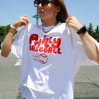 Person wearing a white t-shirt with 'Philly Baseball' text and graphic outdoors.