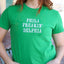 Woman wearing bright green cotton t-shirt with white text reading 'PHILA FREAKIN' DELPHIA'