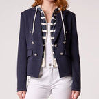 Navy hooded blazer with double-breasted silver buttons, worn open over striped shirt and white pants