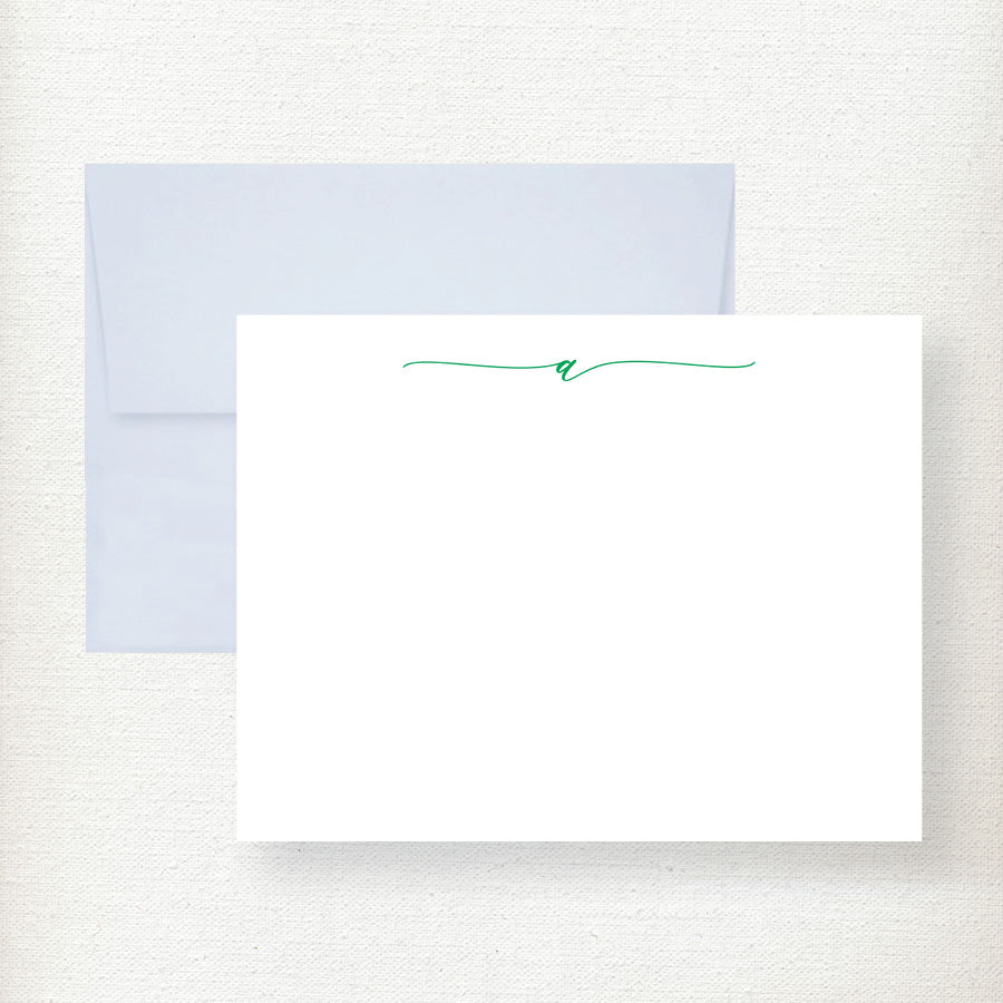 White flat note cards with teal script initial and matching light blue envelopes displayed on cream background Main image