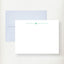 White flat note cards with teal script initial and matching light blue envelopes displayed on cream background