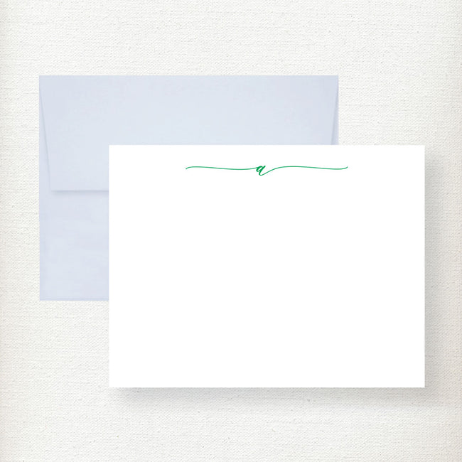 White flat note cards with teal script initial and matching light blue envelopes displayed on cream background Main image