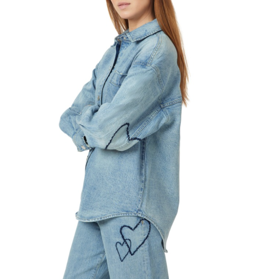Light blue denim shirt jacket worn oversized with embroidered hearts on sleeve and pant leg Main image