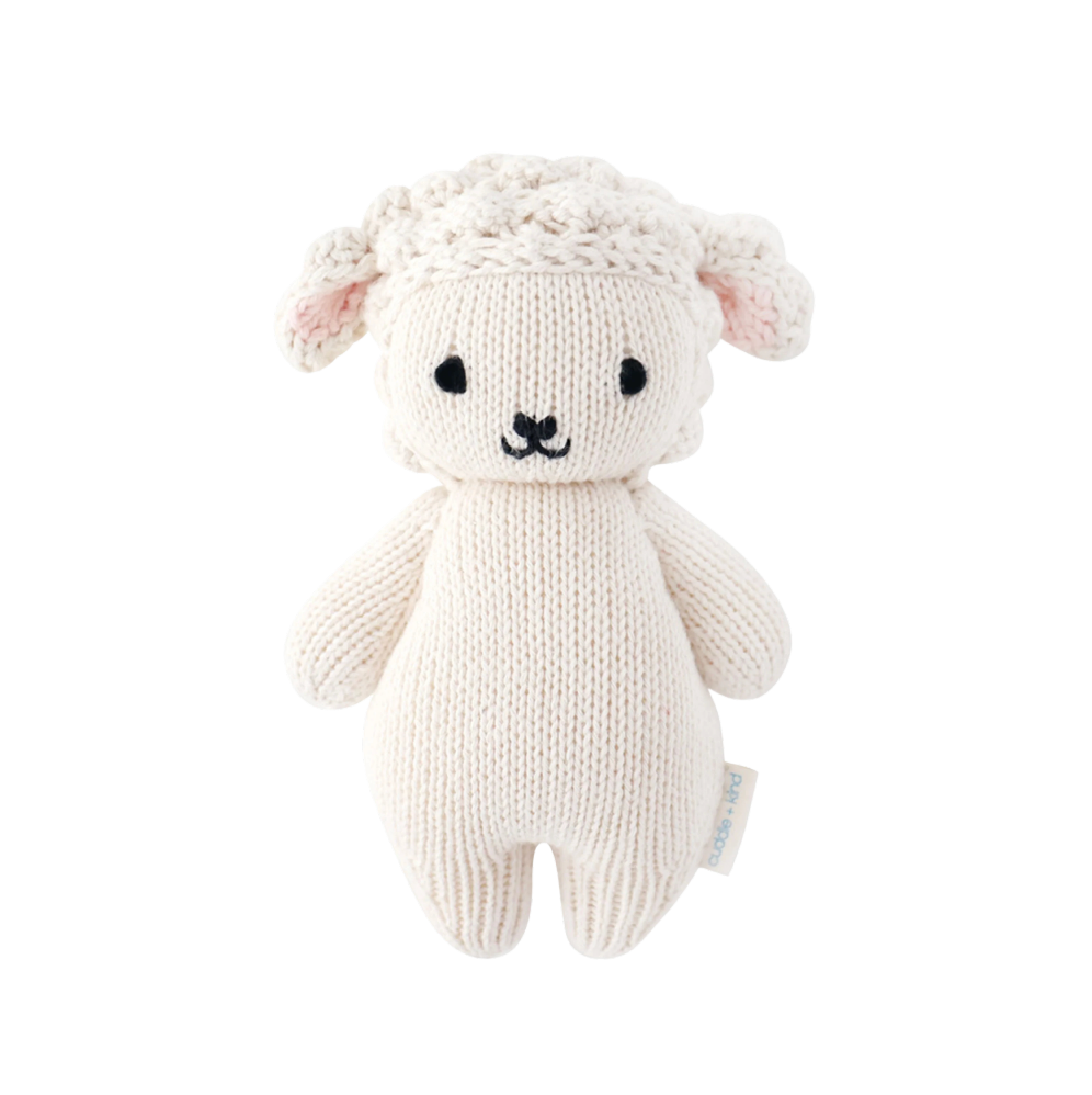 Knitted toy sheep on a white background