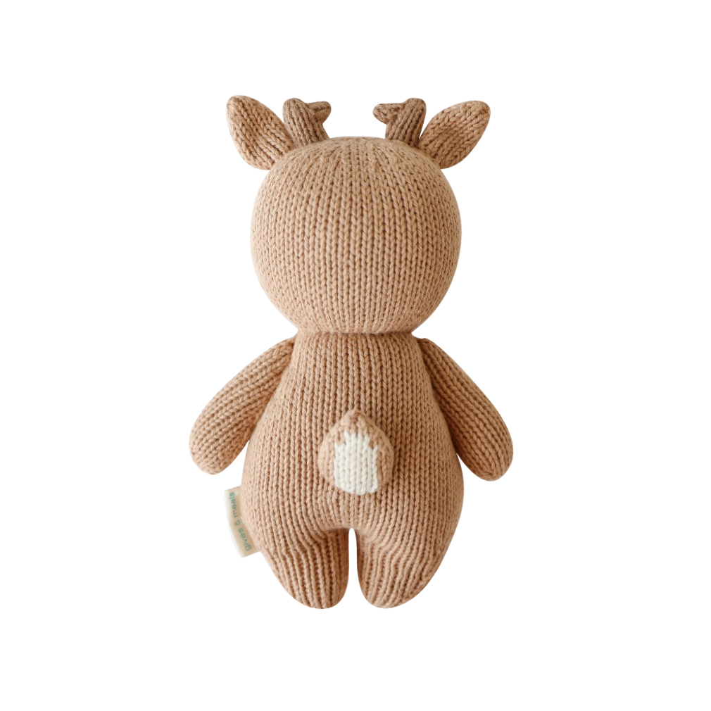 Knitted toy deer on a white background