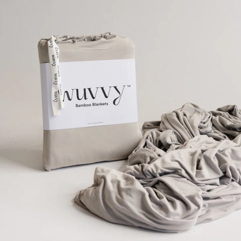Wuvvy small bamboo blanket in cream, packaged in branded box with fabric bundle displayed beside packaging
