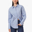 A woman modeling a light blue and white vertically striped button-up shirt with dark blue jeans, set against a plain white studio background.