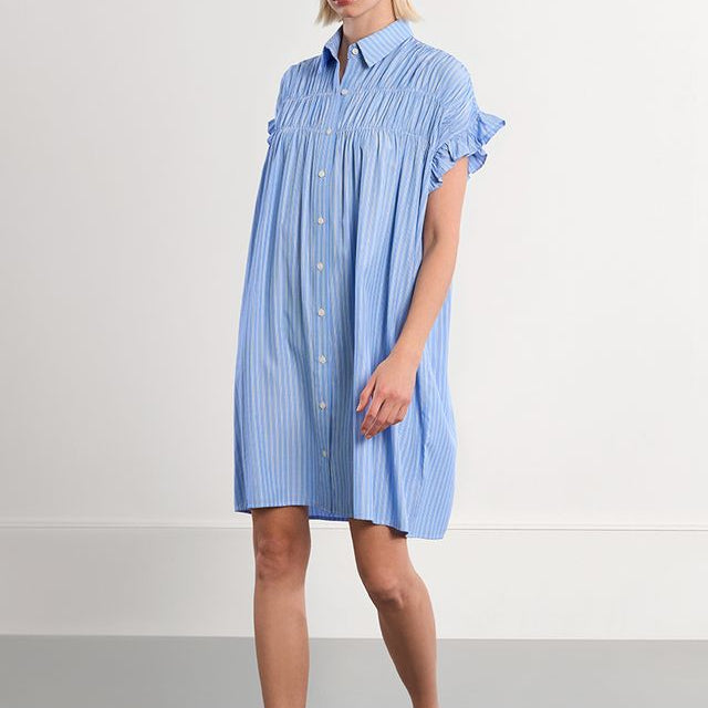 Woman wearing a blue striped dress on a white background