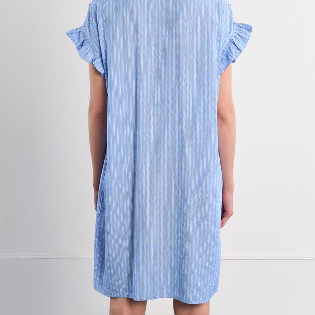Woman wearing a blue striped dress against a white background
