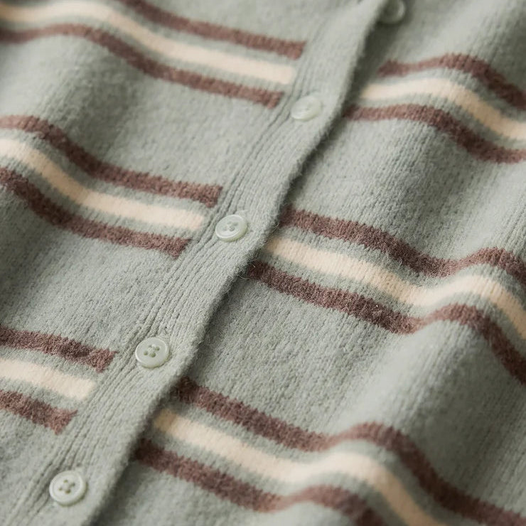 Close-up of a knit button-front cardigan with horizontal wavy stripes in muted sage green, taupe-brown, and cream.