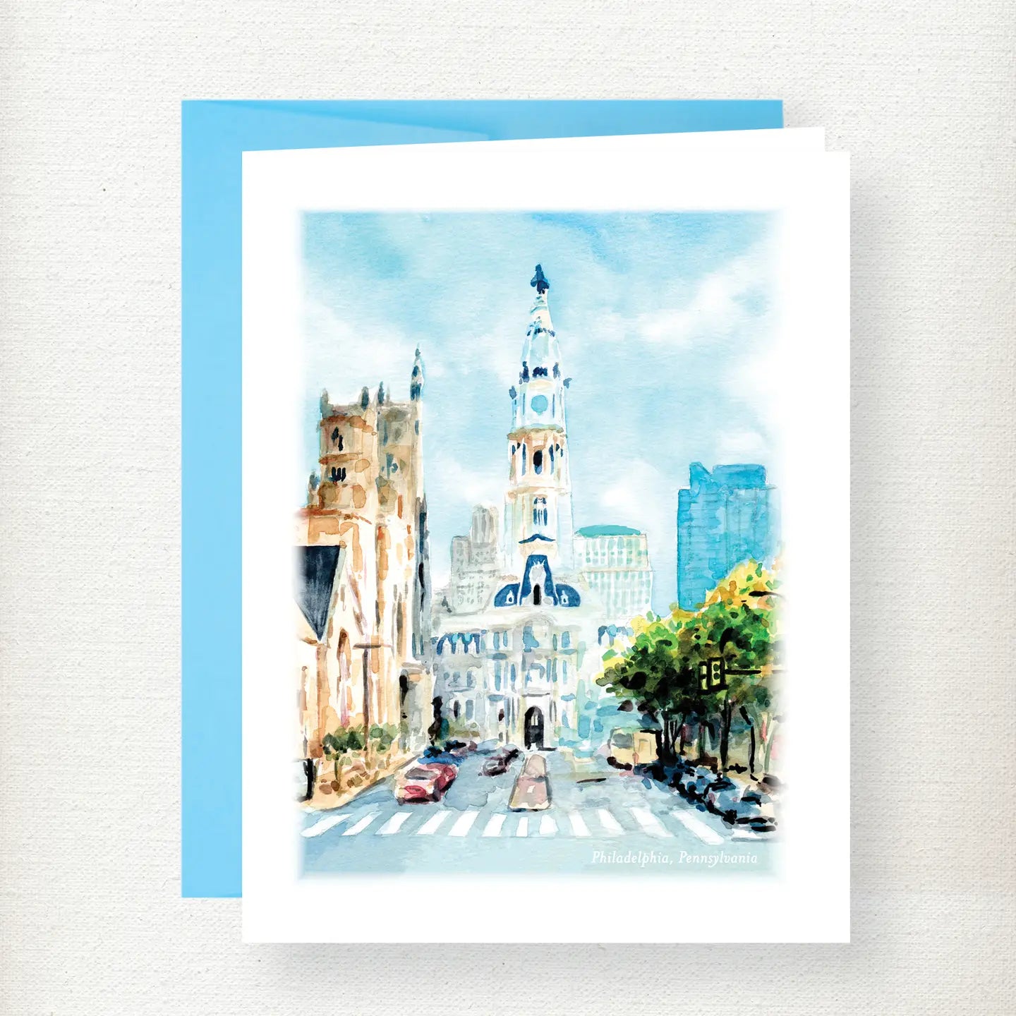 Watercolor illustration of Philadelphia City Hall with tall steeple, historic architecture, and tree-lined street scene