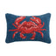 Red crab hook pillow with textured details on navy blue background, coastal home decor