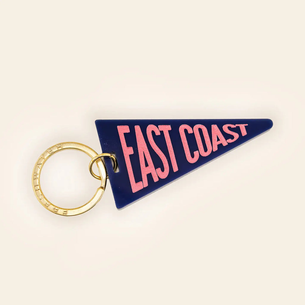 Navy blue pennant flag keychain with pink East Coast text and gold metal key ring