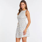 Woman wearing Emile Boat Neck Mini dress in cream with blue and yellow floral print, sleeveless with ruched waist detail