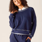 Woman wearing navy Frenchie Tie Side Crewneck sweatshirt with white contrast trim and ribbed cuffs