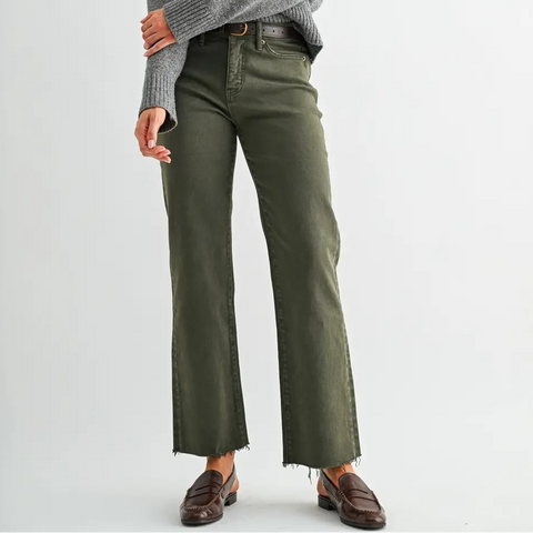 Woman wearing a gray sweater and green pants on a white background