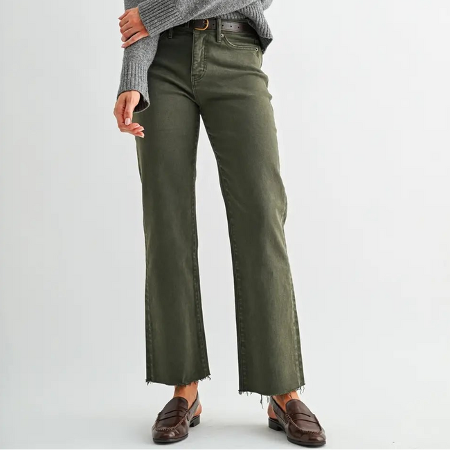 Woman wearing a gray sweater and green pants on a white background Main image