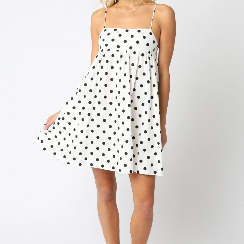 Woman wearing a polka dot dress on a white background