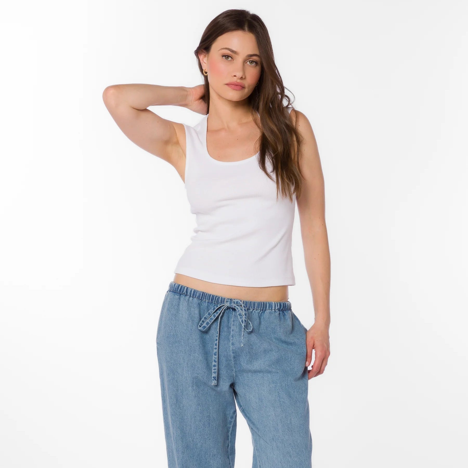 Woman wearing white ribbed square neck tank top with light blue drawstring denim pants against white background Main image