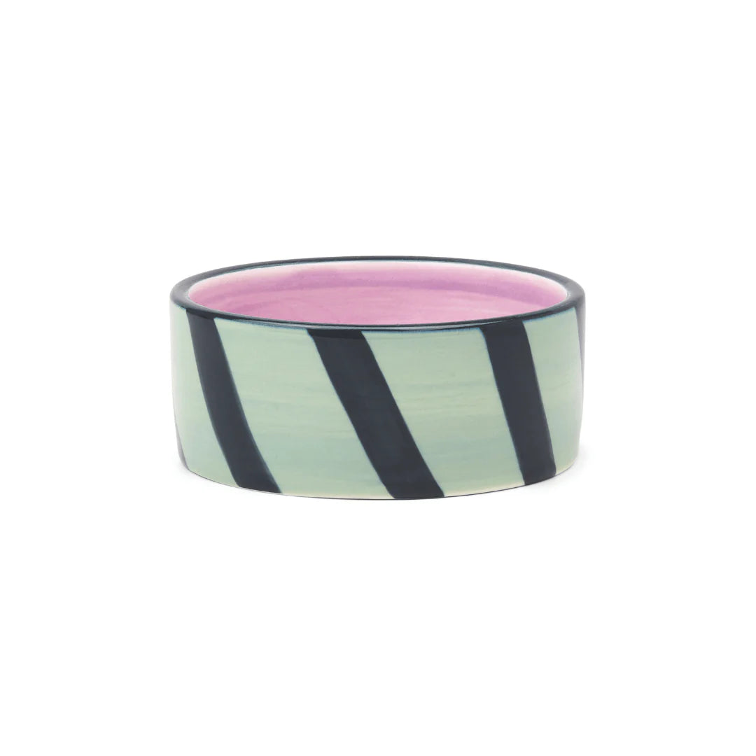 Izzy Wine Coaster with mint green and black diagonal stripes, pink interior, and dark rim