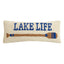 Cream-colored Lake Life hook pillow with blue text and brown paddle design with blue accents