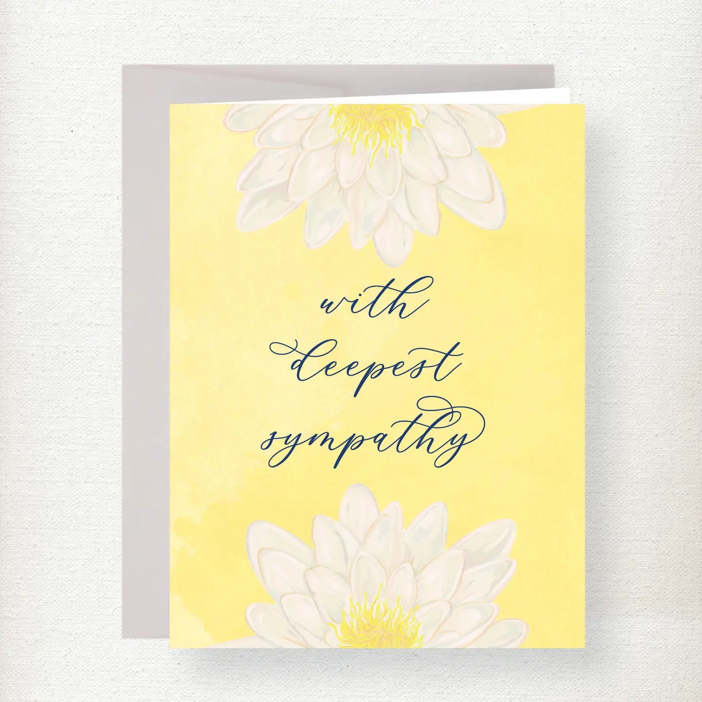 Yellow sympathy greeting card with white lilies and yellow centers, featuring cursive text reading 'with deepest sympathy'