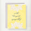 Yellow sympathy greeting card with white lilies and yellow centers, featuring cursive text reading 'with deepest sympathy'