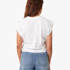 Person wearing a white sleeveless top and blue jeans on a white background