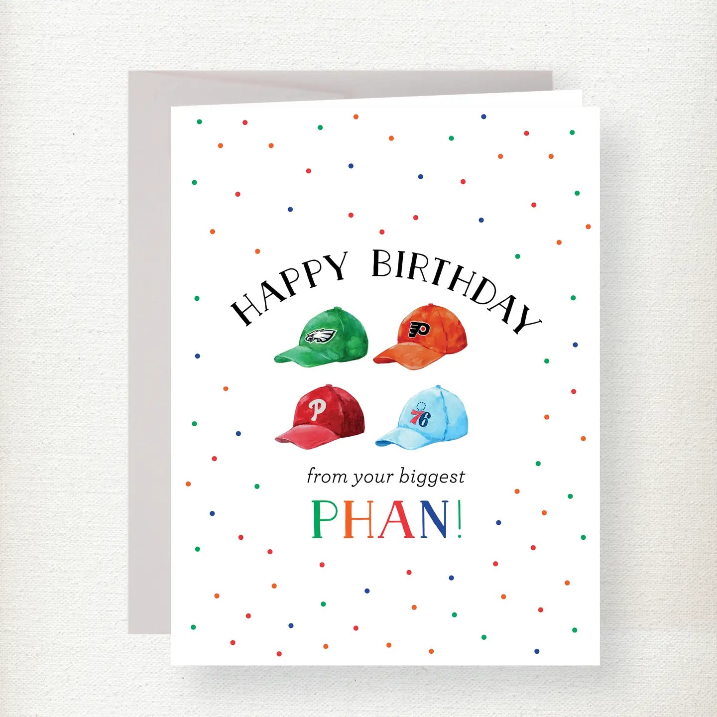 Philadelphia sports birthday greeting card featuring Eagles, Phillies, 76ers, and Flyers caps with colorful confetti dots an…