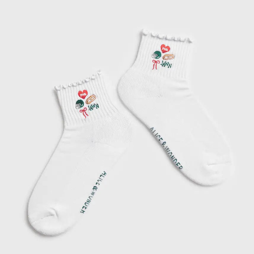 A pair of white crew socks with ruffled edges featuring Philadelphia icons