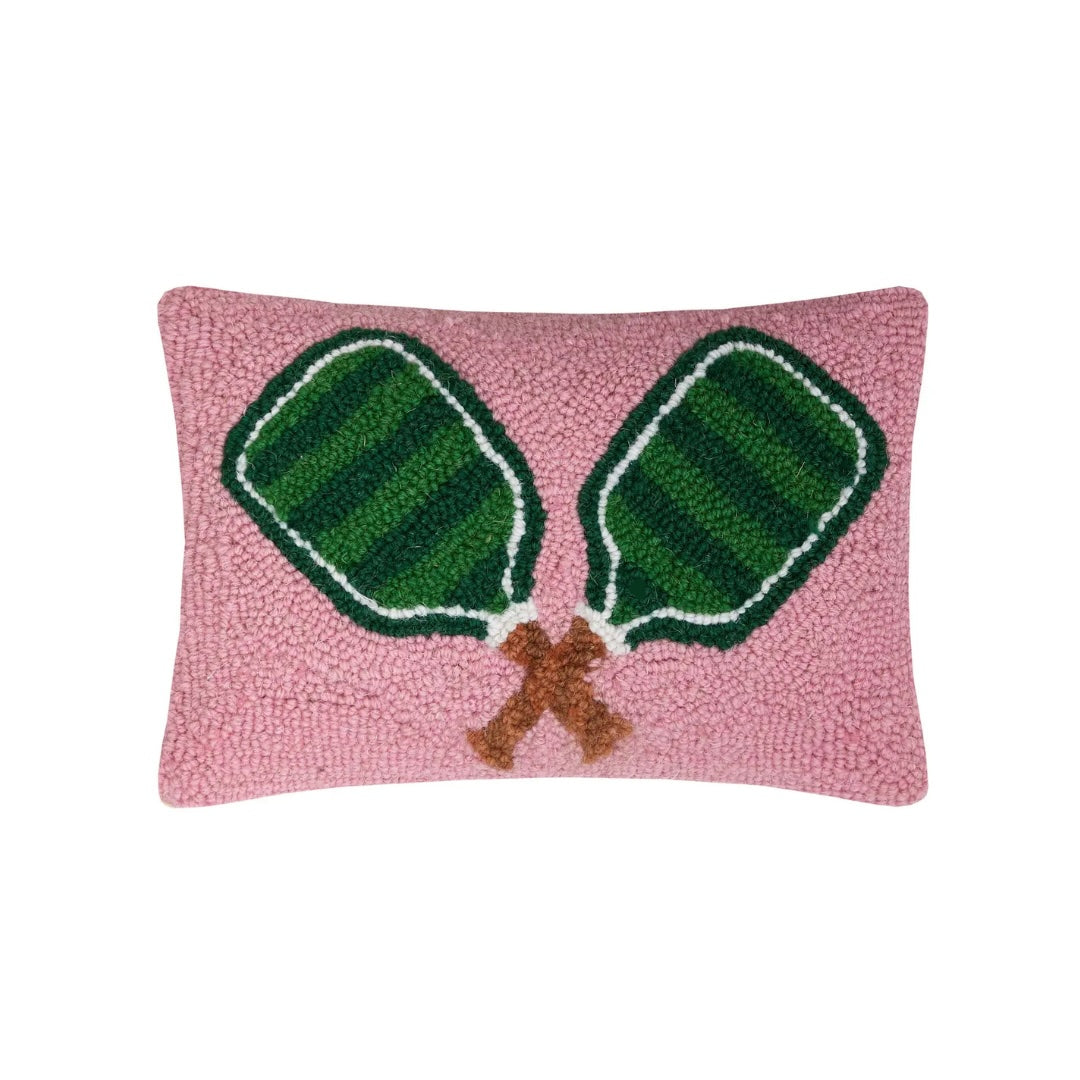 Pink hooked pillow with two green pickleball paddles outlined in white and brown stem detail