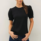 Black cotton jersey puff sleeve tee with crew neckline and short puffed sleeves, styled with dark jeans