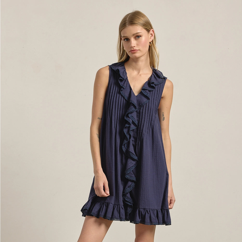Woman wearing navy Ruffle Trim Pintuck Dress with V-neckline, sleeveless design, and ruffled hem detail Main image