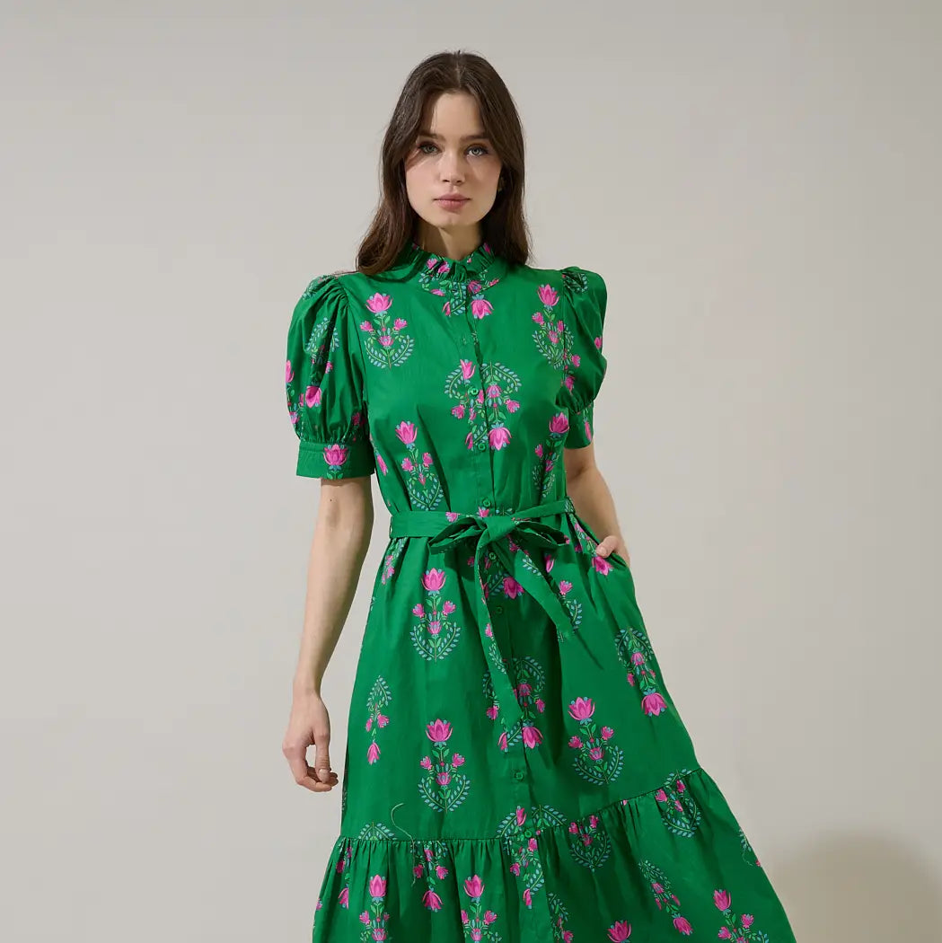 Woman wearing green Saura Floral Giles Button Up Midi dress with pink floral embroidery, puffed sleeves, and tied waist belt Main image