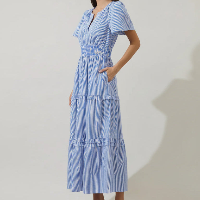 Woman wearing blue and white striped Palmer poplin maxi dress with short sleeves, smocked waist, and tiered skirt