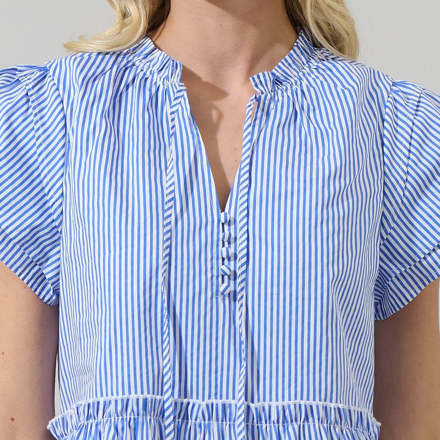 Woman wearing blue and white striped empire waist mini dress with short puffed sleeves and tiered ruffle hem