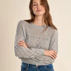 Woman wearing Maris Openwork Knit Tee in light gray with textured cable knit pattern and cropped fit