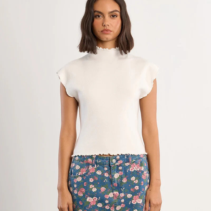 White ribbed ruffle sleeve tee with crew neckline paired with floral denim skirt
