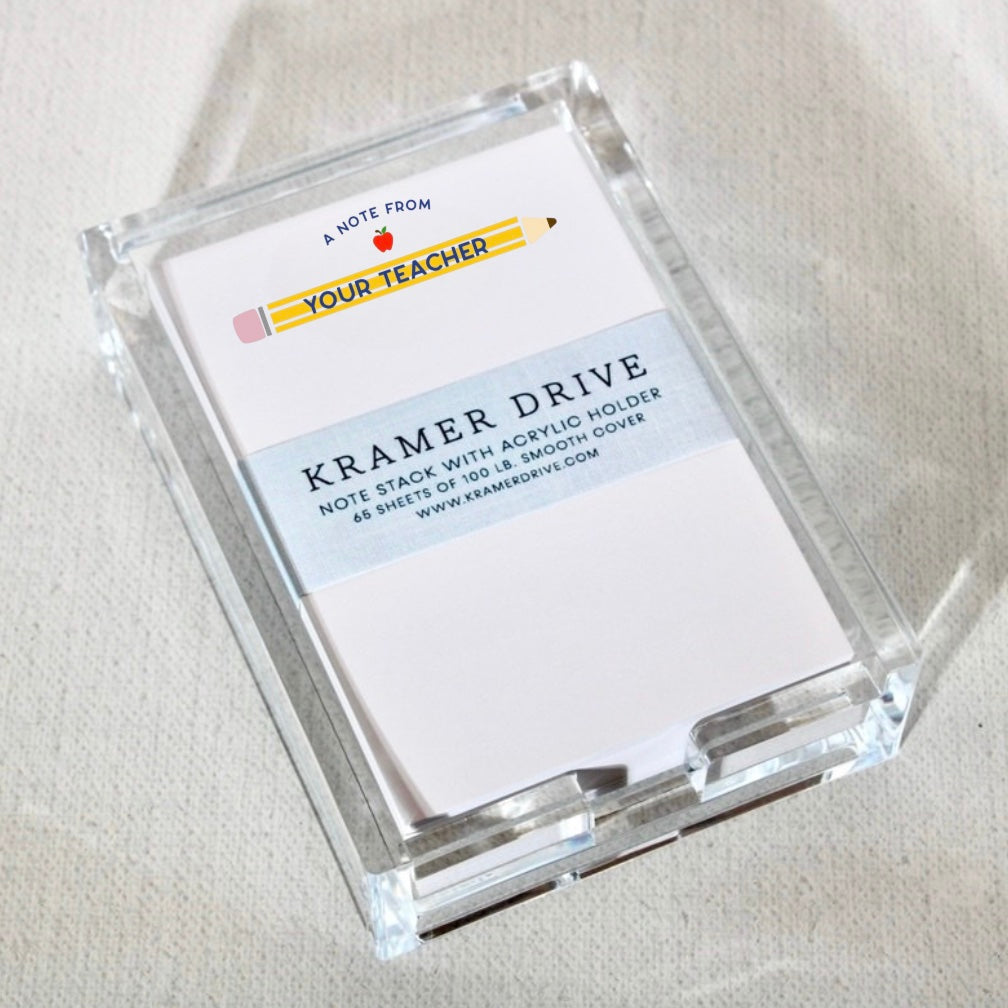 Clear acrylic holder containing stack of teacher note cards with pencil and apple design, labeled 'A Note From Your Teacher'