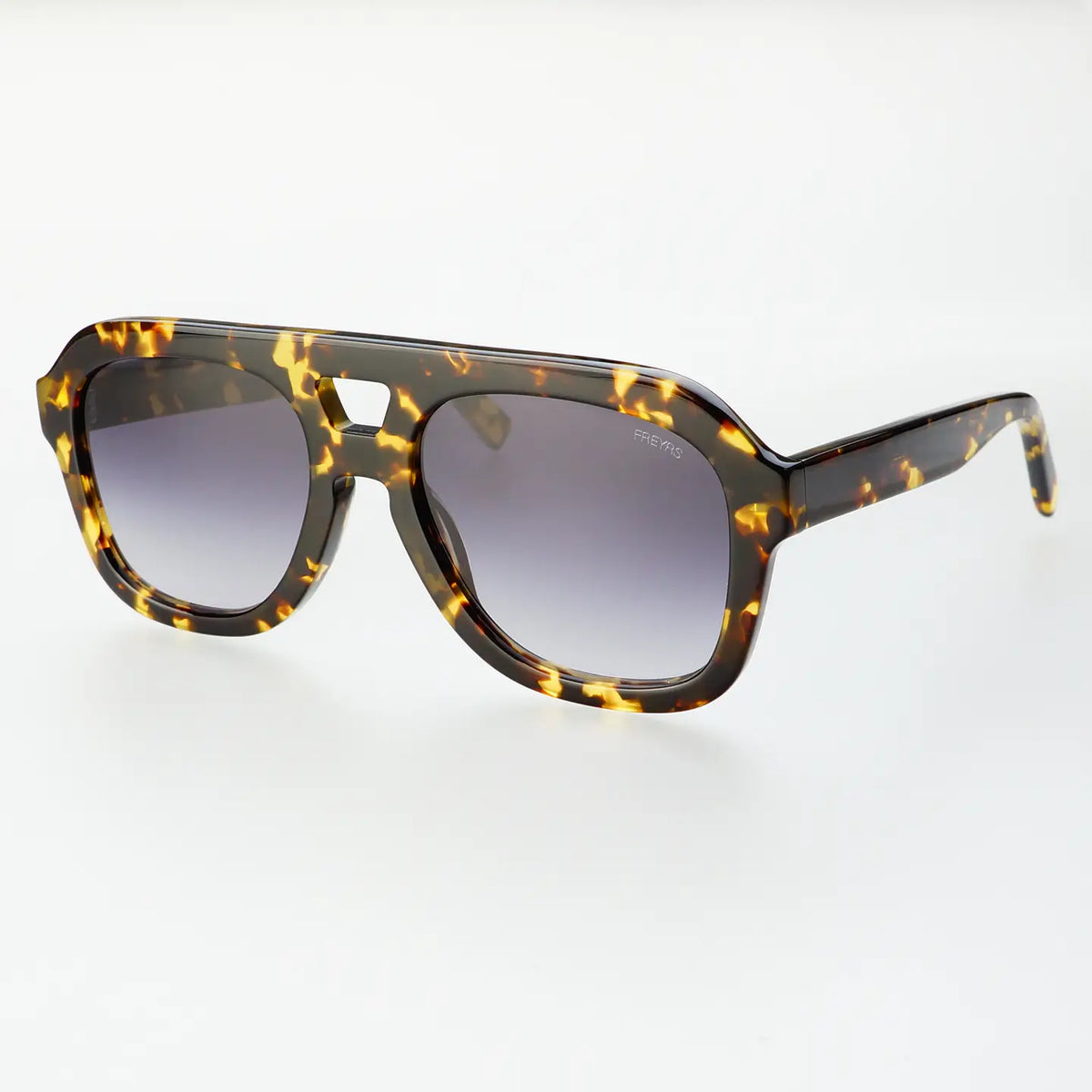 Yellow tortoise sunglasses against a white background. 